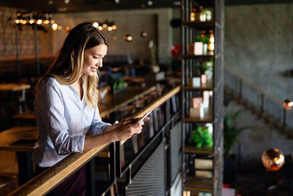Beautiful young woman using mobile phone. Business, technology, social network concept