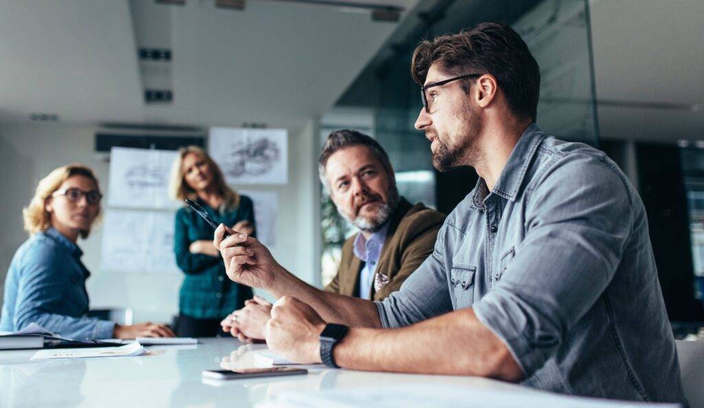 Men in office discussing