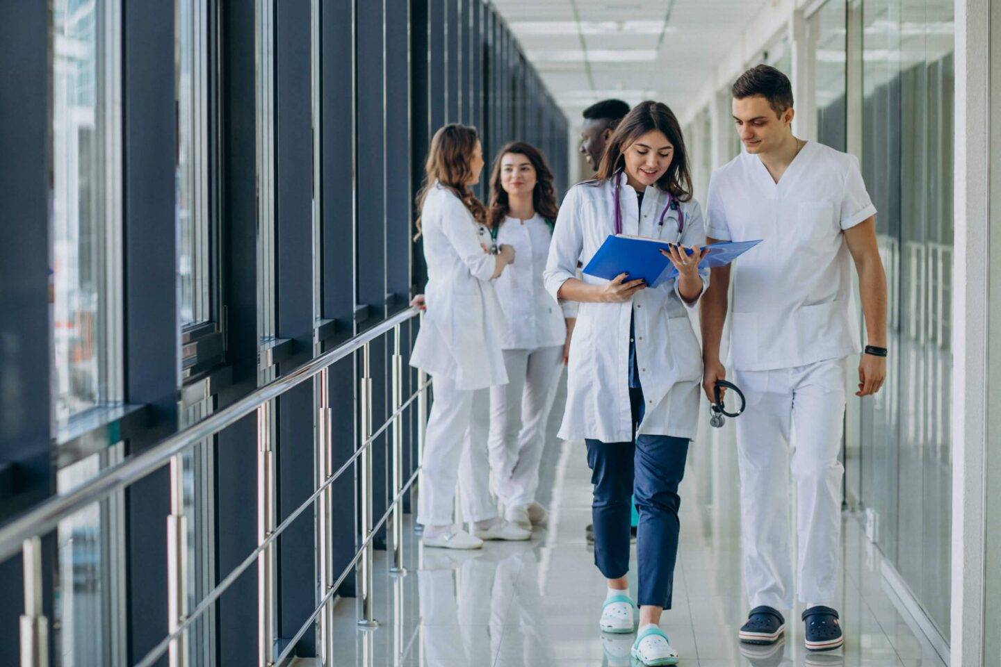 people walking down a corridor in a hospital